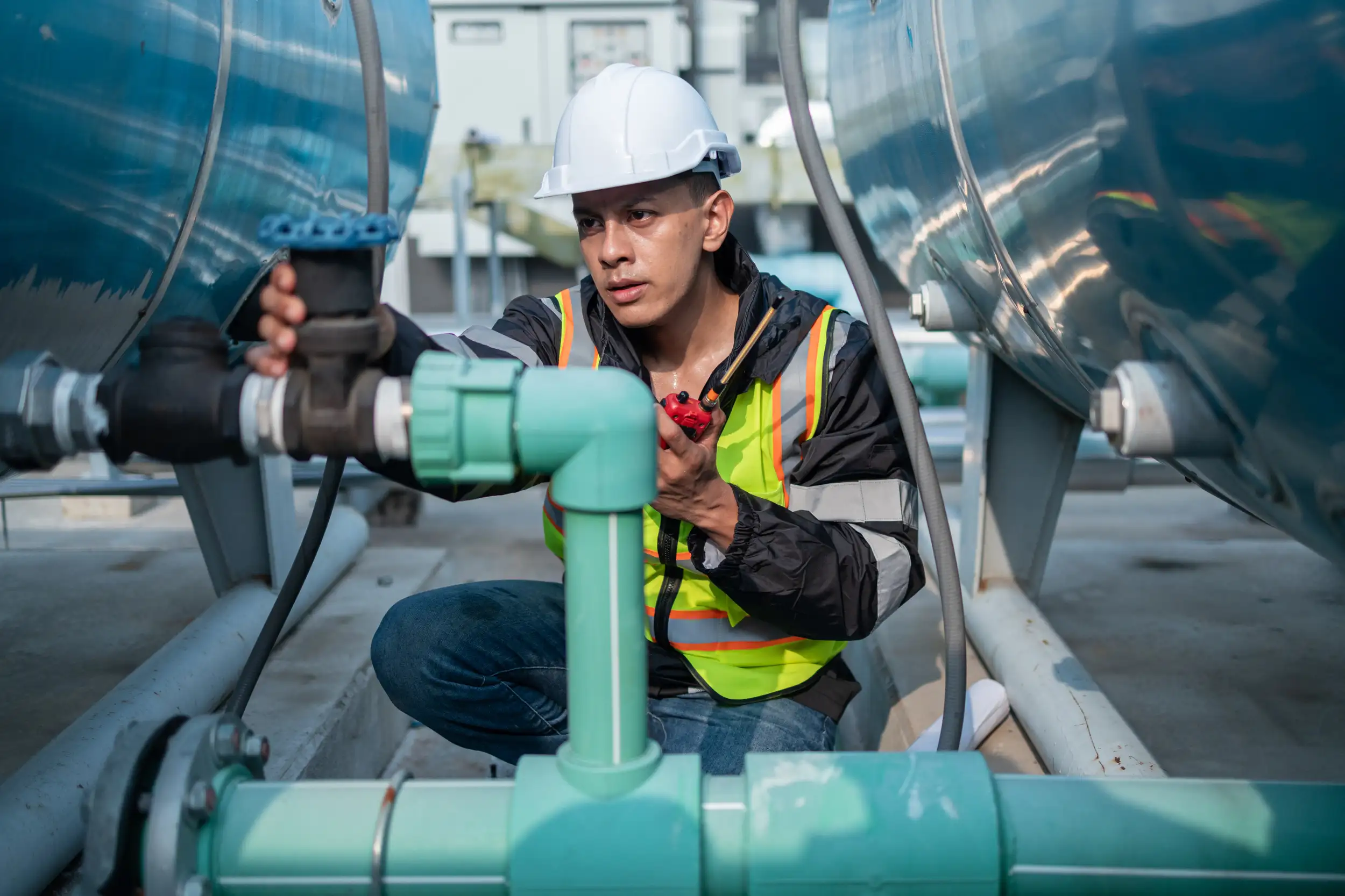 An service worker checking the pipe and equipment.